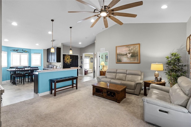 living room featuring light carpet, plenty of natural light, and recessed lighting