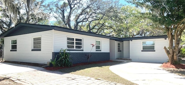 single story home featuring concrete driveway