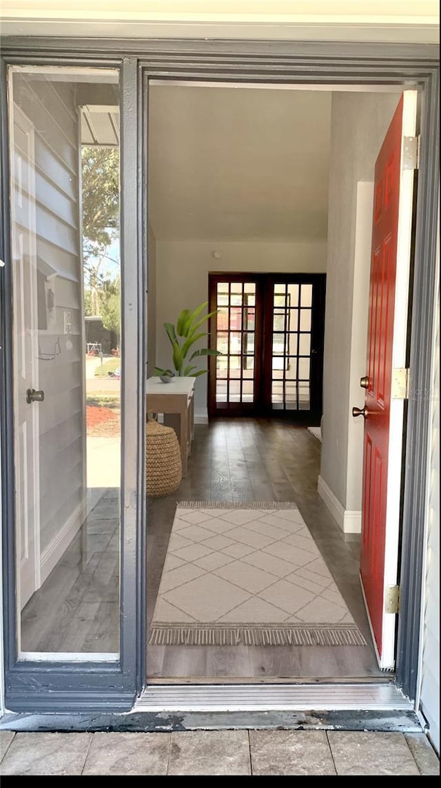 doorway featuring french doors and baseboards