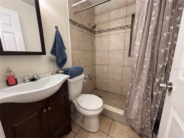 full bath with toilet, a stall shower, vanity, and tile patterned flooring