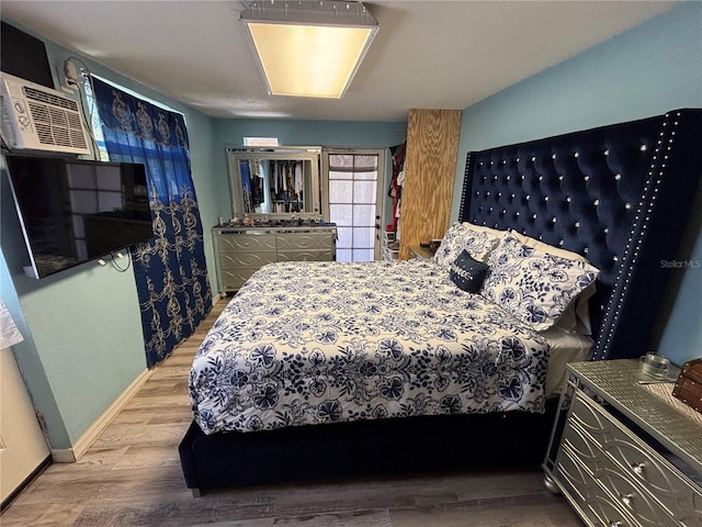 bedroom with baseboards and wood finished floors