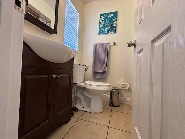 bathroom with tile patterned floors, toilet, vanity, and baseboards