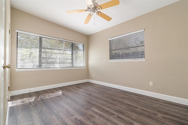 spare room featuring vaulted ceiling, wood finished floors, baseboards, and ceiling fan