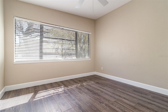 unfurnished room with dark wood-style floors, baseboards, and ceiling fan