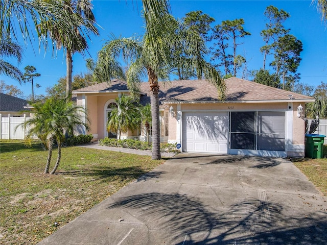 view of front of home featuring stucco siding, driveway, a garage, and a front lawn