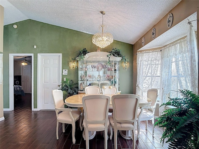 dining area featuring vaulted ceiling, baseboards, dark wood-type flooring, and a textured ceiling