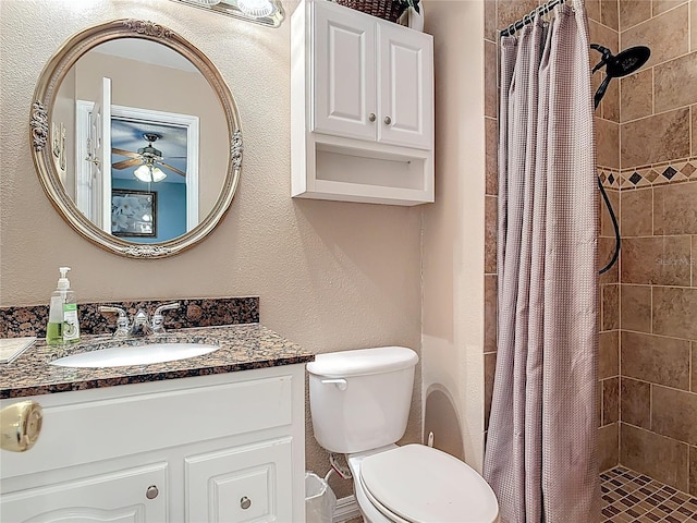 full bath featuring toilet, a stall shower, and vanity