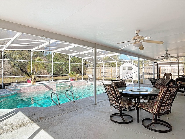 view of pool featuring a ceiling fan, an in ground hot tub, a fenced backyard, a lanai, and a patio area