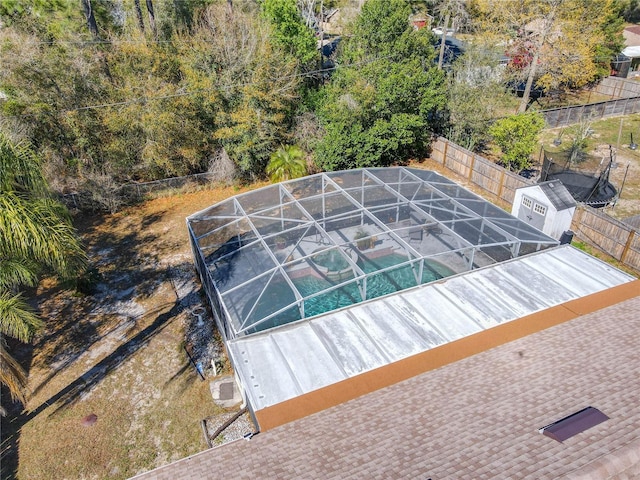 view of swimming pool featuring a lanai, fence, and a fenced in pool