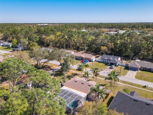 birds eye view of property with a forest view and a residential view