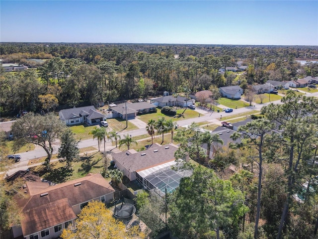 aerial view featuring a forest view and a residential view