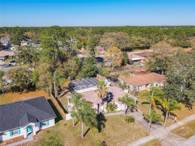 birds eye view of property with a view of trees and a residential view