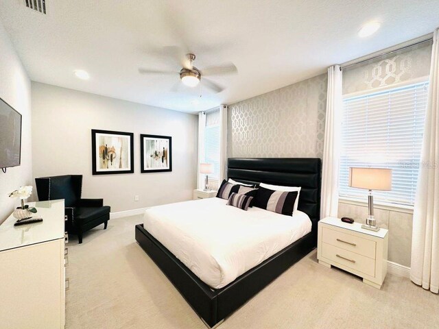 bedroom with ceiling fan, recessed lighting, light colored carpet, baseboards, and wallpapered walls