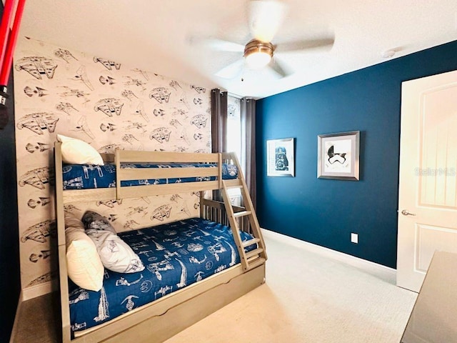 bedroom featuring carpet flooring, ceiling fan, baseboards, and wallpapered walls