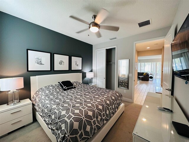 bedroom featuring ceiling fan, visible vents, a closet, and carpet flooring