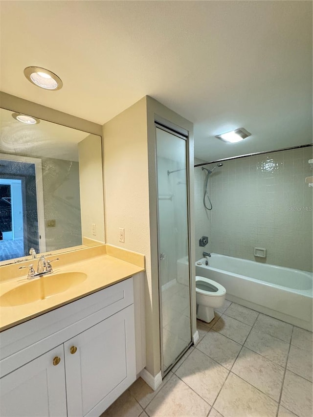 bathroom with toilet, tile patterned flooring, and vanity