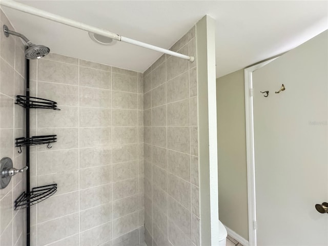 full bath featuring a shower stall and toilet