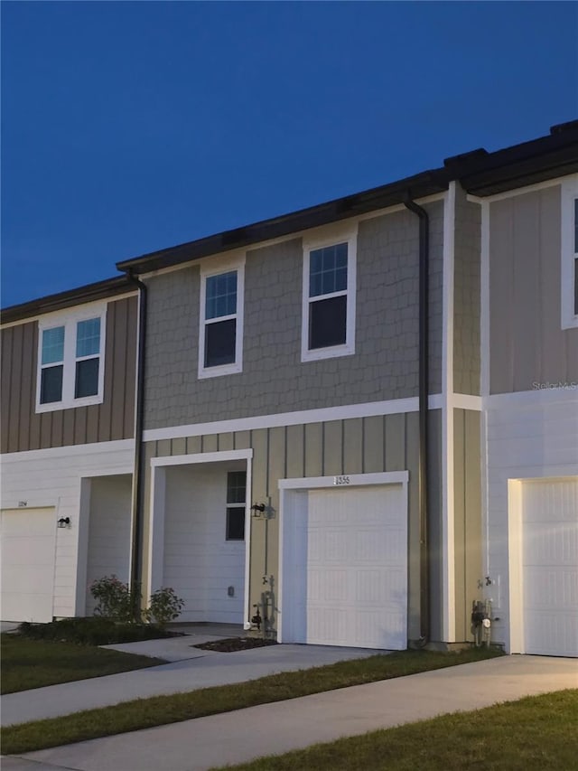 view of front facade with board and batten siding and an attached garage