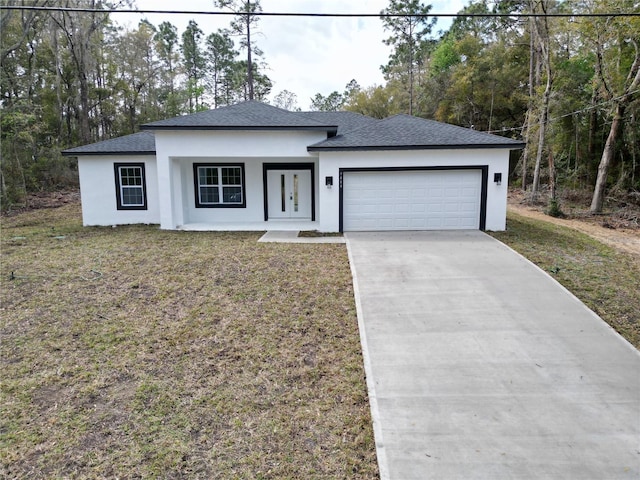 view of front of house with a garage, a shingled roof, concrete driveway, stucco siding, and a front lawn