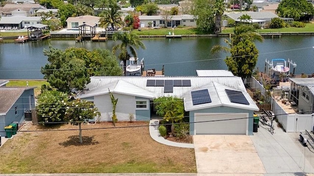 drone / aerial view featuring a residential view and a water view