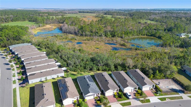 bird's eye view with a residential view, a water view, and a view of trees