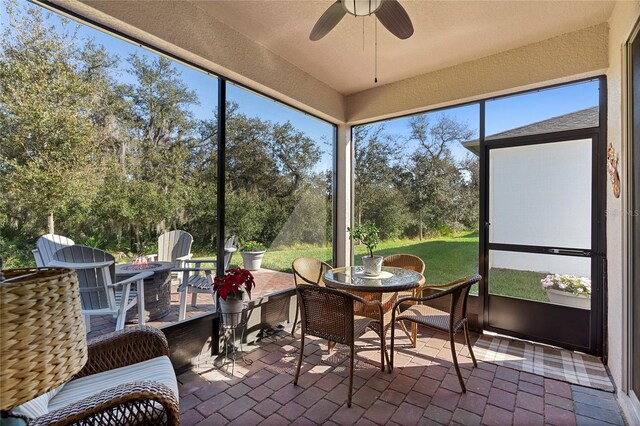 sunroom featuring a ceiling fan