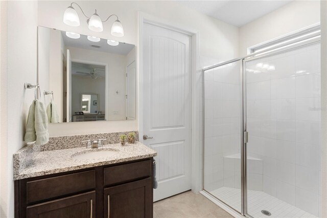 bathroom with vanity, a stall shower, and tile patterned flooring