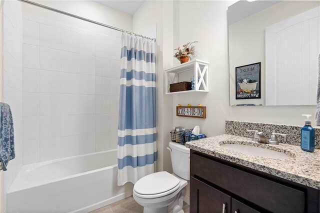 bathroom featuring tile patterned floors, toilet, vanity, and shower / bath combination with curtain