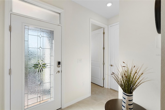 entrance foyer featuring light tile patterned floors and baseboards