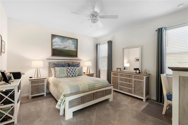 bedroom featuring multiple windows, a ceiling fan, and carpet