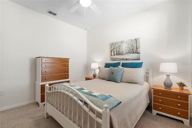 carpeted bedroom featuring visible vents, baseboards, and a ceiling fan