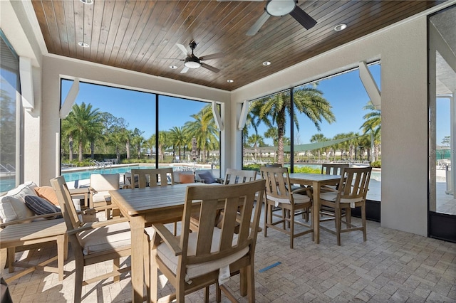 sunroom with plenty of natural light and wood ceiling