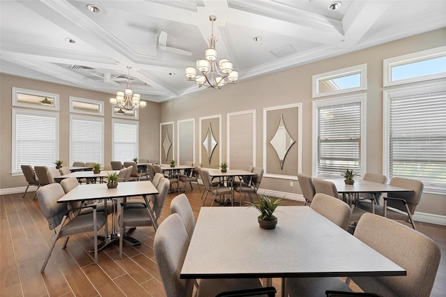 dining space featuring wood finished floors, baseboards, and a chandelier