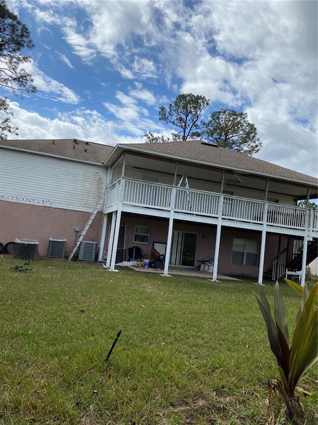 back of house featuring a patio area, a deck, central AC, and a yard