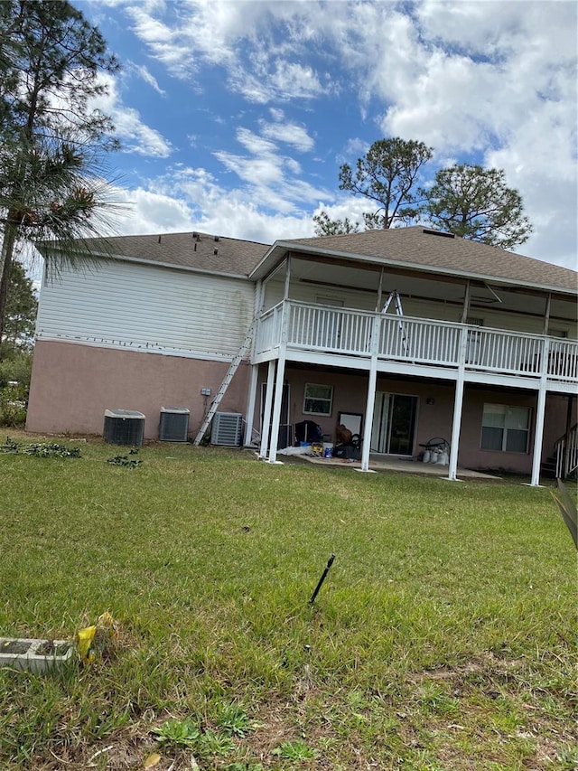 back of property featuring cooling unit, a patio, and a yard