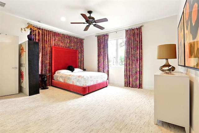 carpeted bedroom with ceiling fan, visible vents, and baseboards