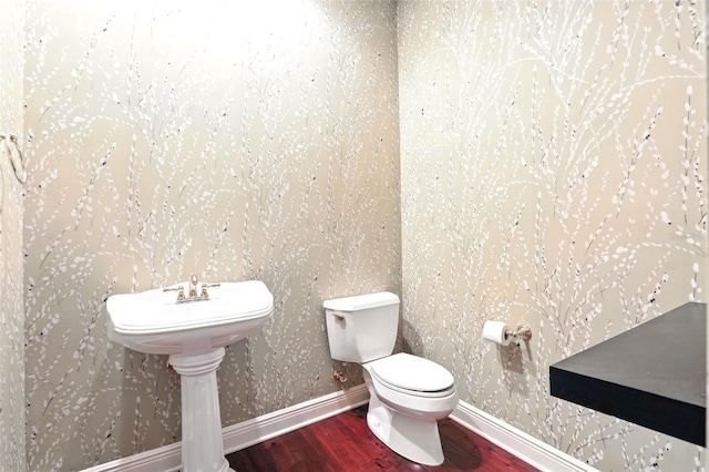 bathroom featuring wood finished floors, toilet, and baseboards