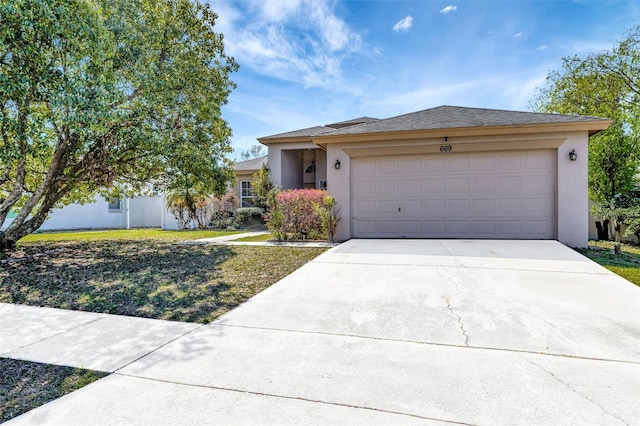 view of front of home featuring stucco siding, a garage, concrete driveway, and a front yard