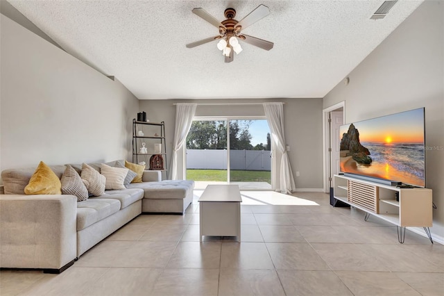 living area with visible vents, baseboards, light tile patterned flooring, a textured ceiling, and a ceiling fan