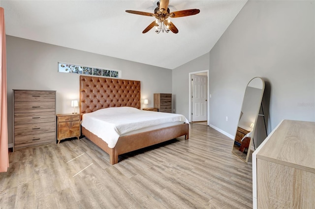 bedroom with vaulted ceiling, wood finished floors, baseboards, and ceiling fan