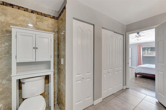 bathroom featuring a closet, toilet, and tile patterned flooring