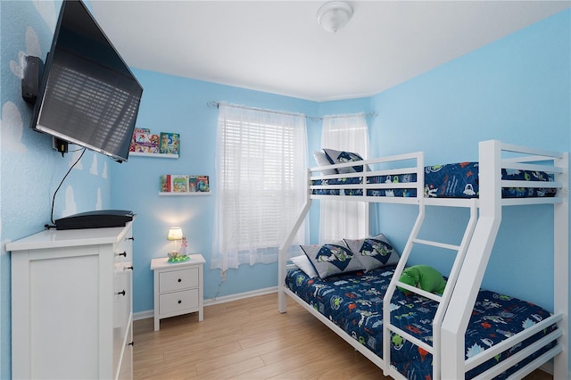 bedroom featuring baseboards and wood finished floors