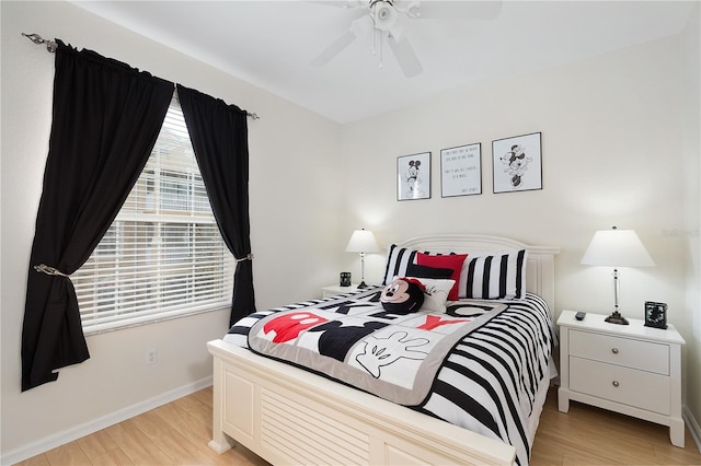 bedroom featuring light wood finished floors, ceiling fan, and baseboards