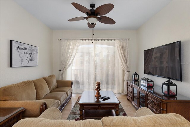 living room with light wood finished floors and a ceiling fan