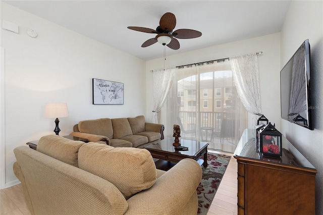 living room featuring light wood-type flooring and ceiling fan