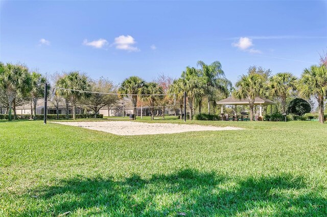 surrounding community with a gazebo, a yard, and volleyball court