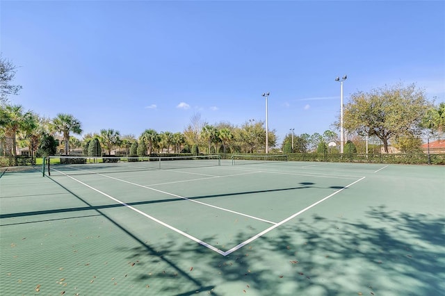 view of sport court featuring fence