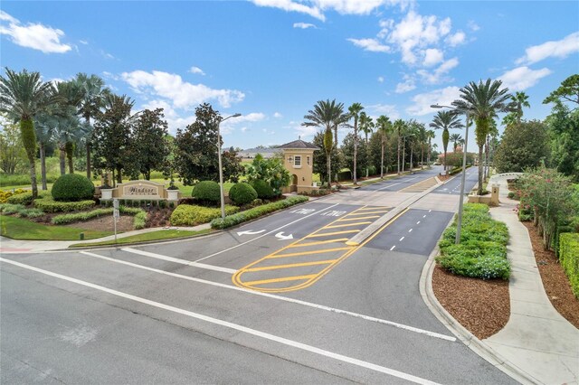 view of street with curbs, street lighting, and sidewalks