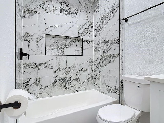 bathroom featuring shower / washtub combination and toilet