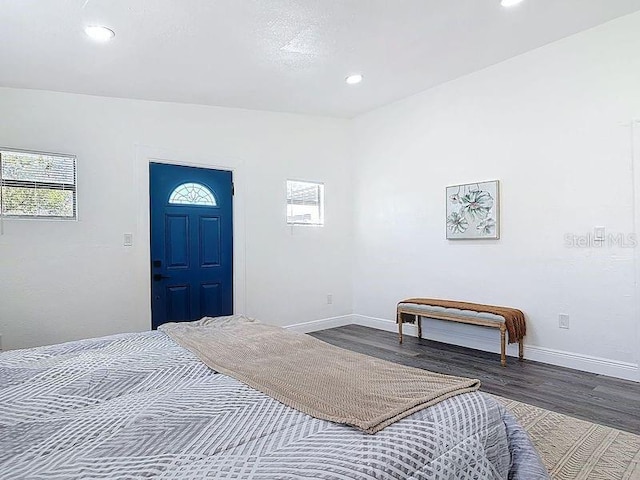 bedroom featuring baseboards, wood finished floors, and recessed lighting